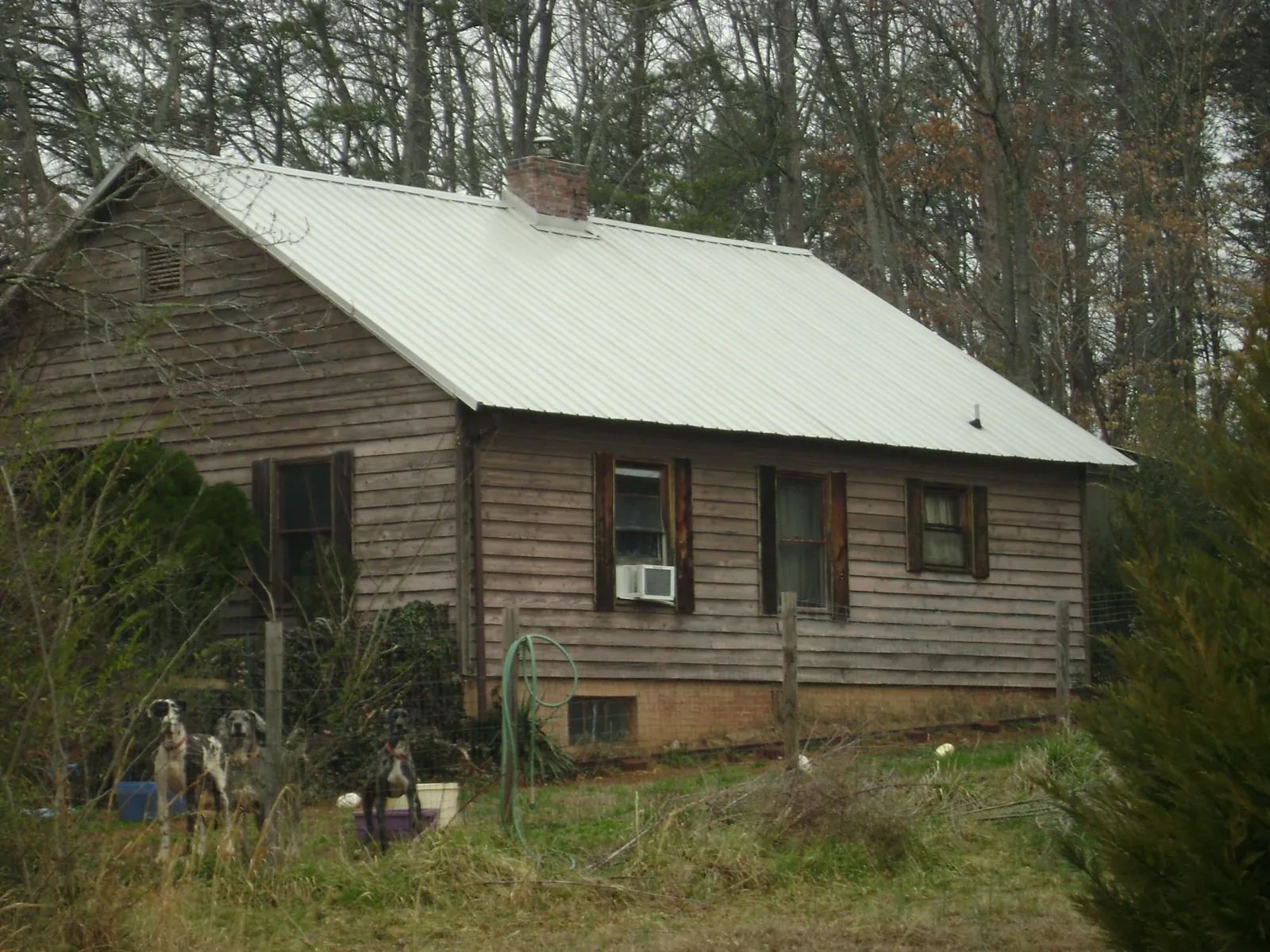 White metal roof on an old wood sided farmhouse, from a Metal Roof Installation job in Round Top