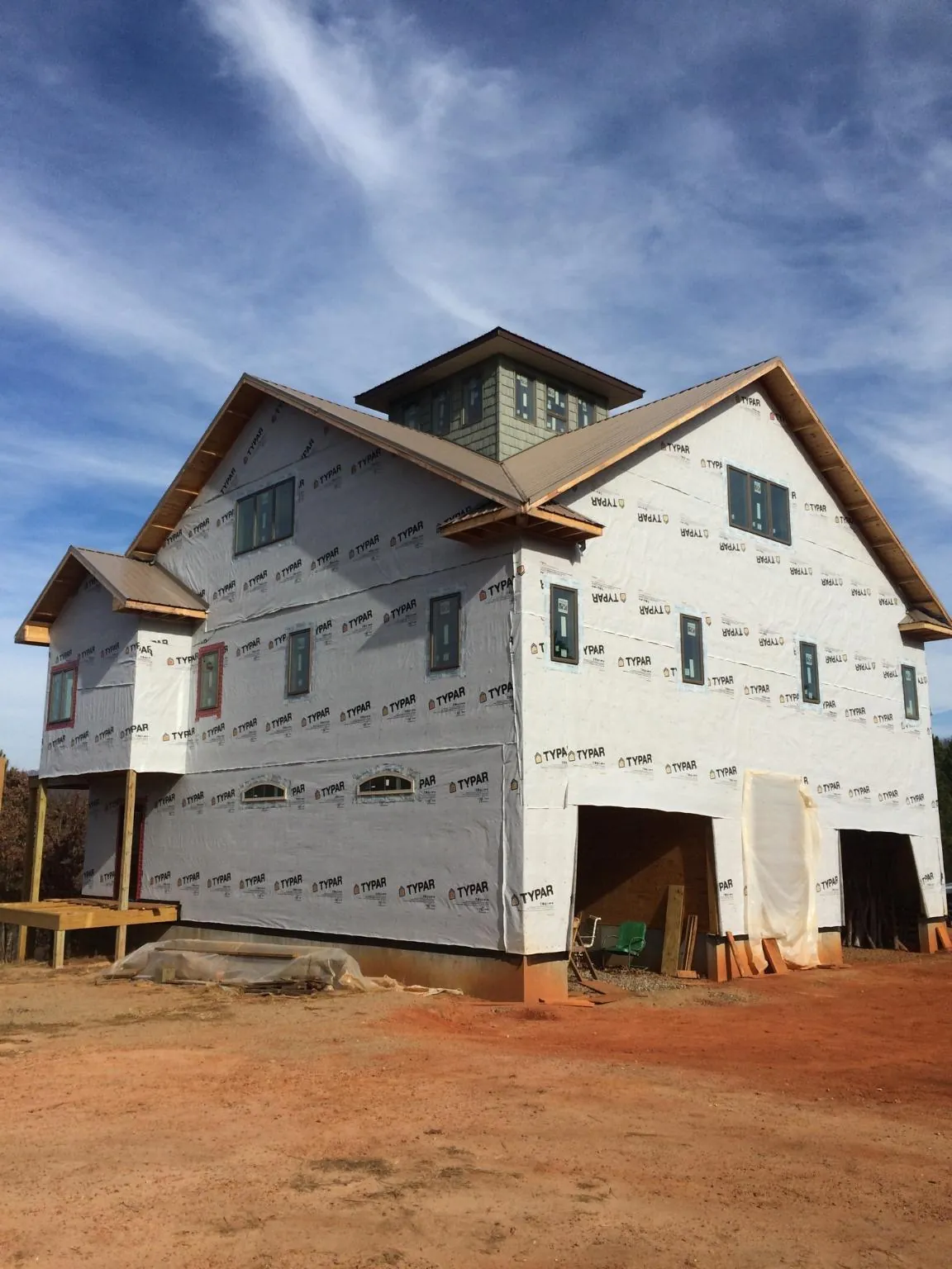 New two story house under construction with a cupola and gabled roofs in Round Top